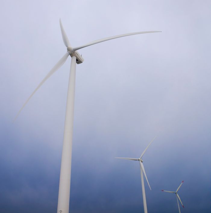 Crafting Captivating Headlines: Your awesome post title goes here Wind turbines generating clean energy against a cloudy sky backdrop.